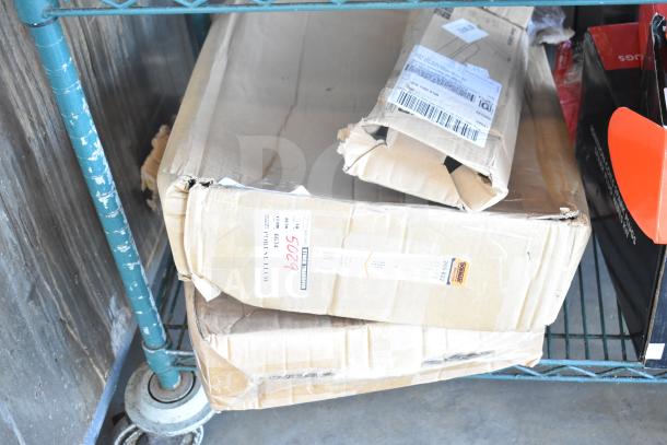 Three damaged boxes labeled "Brand New Scratch and Dent" items, including a shower caddy, on a metal shelf.