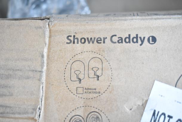 Cardboard box labeled "Shower Caddy L," showing adhesive model A1347000-B. Item is part of 3 new scratch and dent auction items.