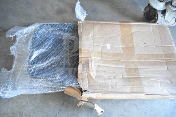 Box containing 3 brand new scratch and dent items, including a shower caddy, partially wrapped in bubble wrap with visible wear.