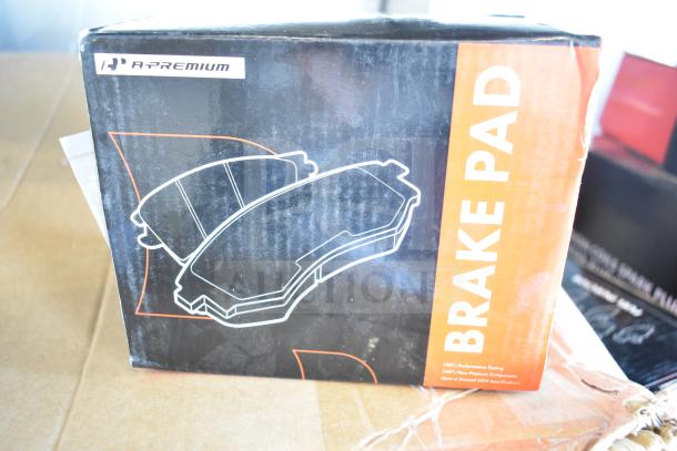 A-Premium Brake Pad box, new condition, visible scratch and dent. Includes brake pad, fuel injector, control arm kit.