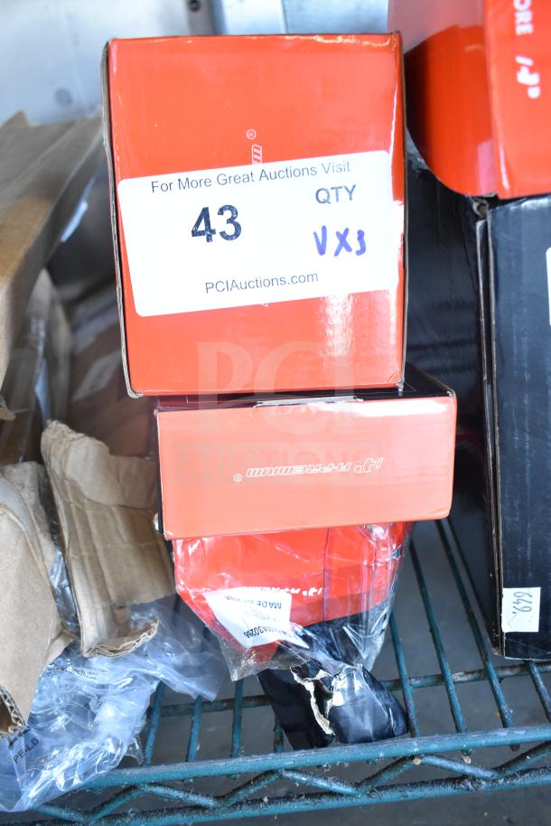 Boxes of brand new scratch and dent auto parts: brake pad, fuel injector, control arm kit, showing auction tags.