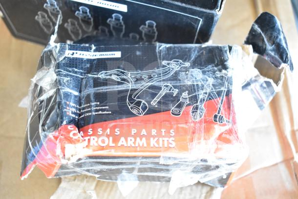 3 brand new scratch and dent auto parts in boxes, including brake pad, fuel injector, control arm kit.