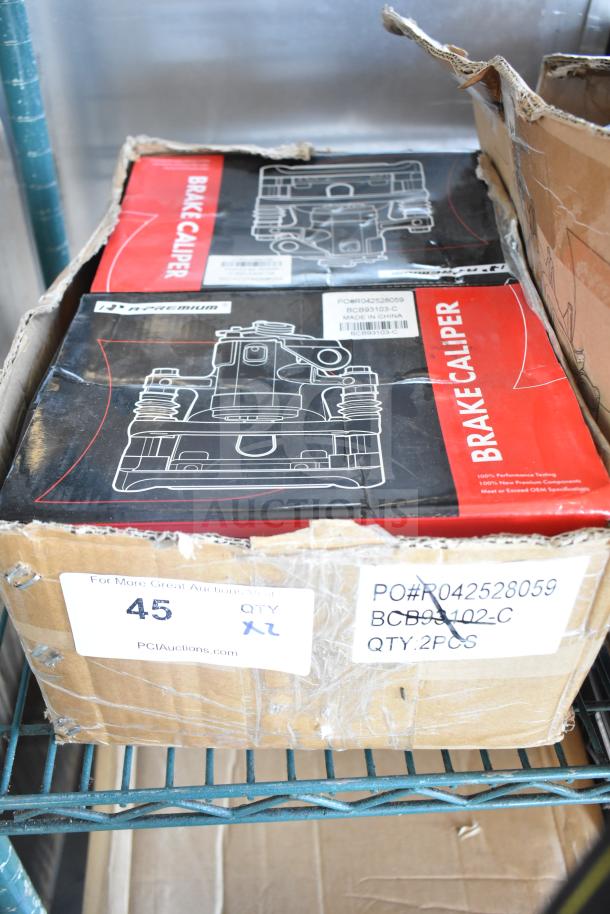 Box of two new scratch and dent brake calipers, labeled BCB93102-C, in packaging with minor damage. Quantity: 2 pieces.