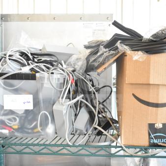 Lot of various cables and gaskets in plastic bin and Amazon box. Includes power cords and audio-video cables. Condition untested.