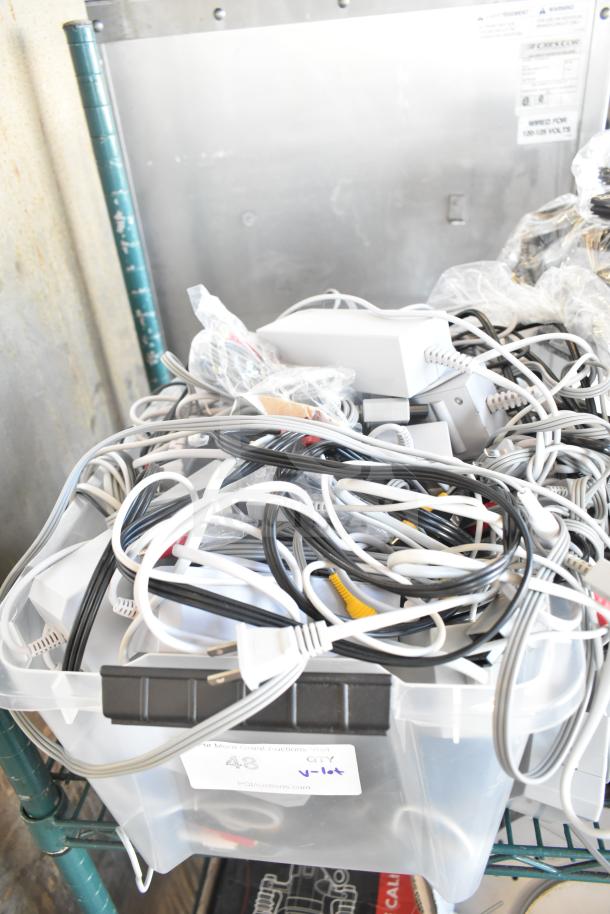Lot of assorted cables and gaskets in plastic bin, various types and colors, lightly used, includes some coiled cables.