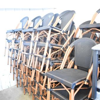 47 black mesh back and seat chairs with wooden frames, stackable design. Scratch and dent condition. Auction lot of 47.