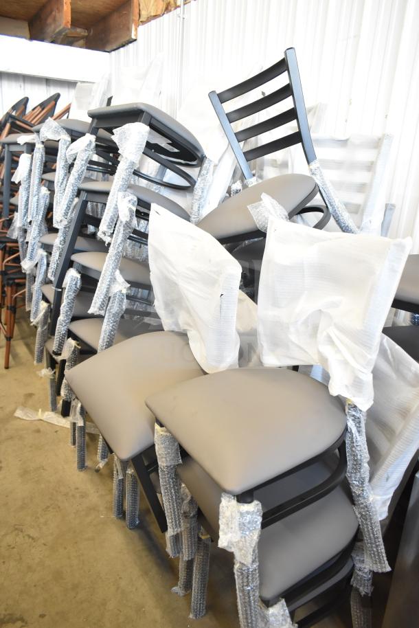 38 brand new ladder back dining chairs with tan/gray cushions, shown with protective wrapping. Scratch and dent condition.