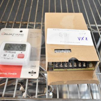 AvaTime Digital Timer in package and Mean Well LRS-150-12 12.5 Amp Power Supply on shelf, cardboard box slightly opened.