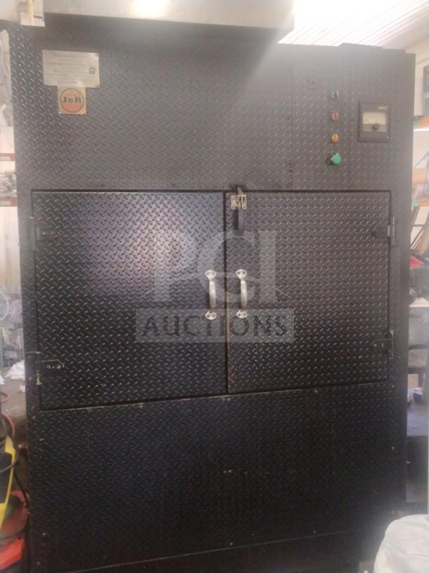 J&R Manufacturing Oyler 1300E smoker, black steel, diamond plate finish, dual doors, control panel visible, used condition.