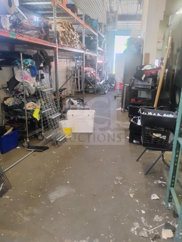 Industrial storage area with shelves, assorted items, and tools; no visible J&R Manufacturing Oyler 1300E smoker.