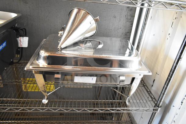 A new Choice chafer with a shiny stainless steel lid and dough dropper hopper, minor scratches visible, on a metal shelf.