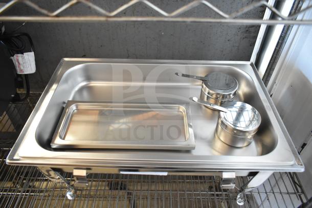Stainless steel chafer with two pots and lids, new scratch and dent condition, displayed on a wire rack.