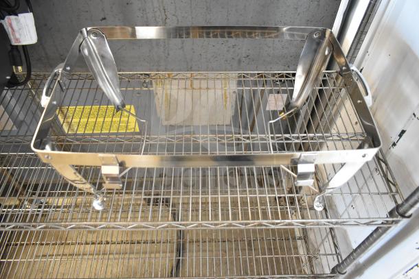 Stainless steel chafer frame on a wire rack, part of a new scratch and dent auction lot.