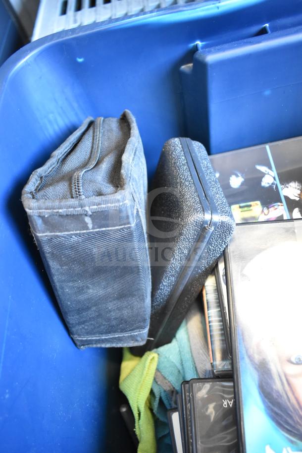 Lot of 2 bins containing LG DVD player, various DVDs, and accessories in a blue storage bin.