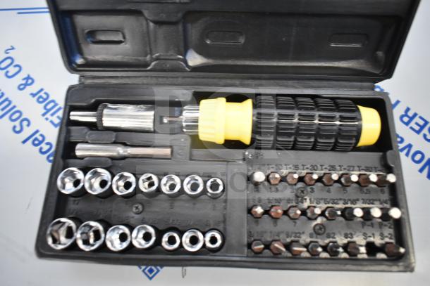 Tool kit in plastic case with screwdriver, various bits, and sockets. Black case with yellow and black handle.