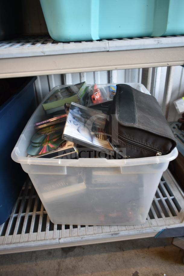 Lot of 2 bins containing various items, including an LG DVD player and DVDs. Items are in used condition.