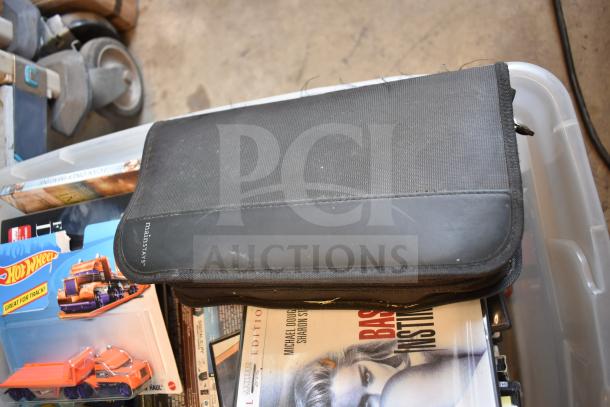 Lot of 2 bins containing various items including an LG DVD player, DVDs, Hot Wheels toy truck, and a Mainstays black case.