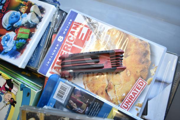 Lot with various DVDs, LG DVD player not visible. Includes assorted films, some unrated. Condition varies.