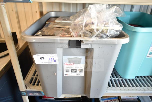 Lot of 2 bins filled with various items including DVDs, in used condition. Sterilite 18 Gal bins with visible labels.