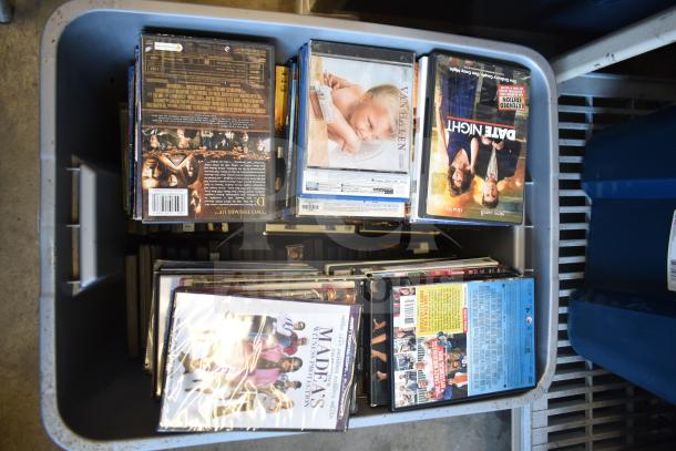 Lot of 2 bins filled with assorted DVDs, including "Date Night" and "Madea's Witness Protection," in fair condition.