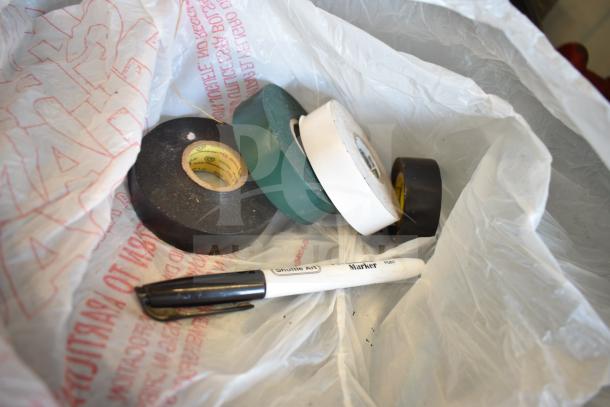 Lot of various items including electrical tape rolls and a black marker in white plastic bag.