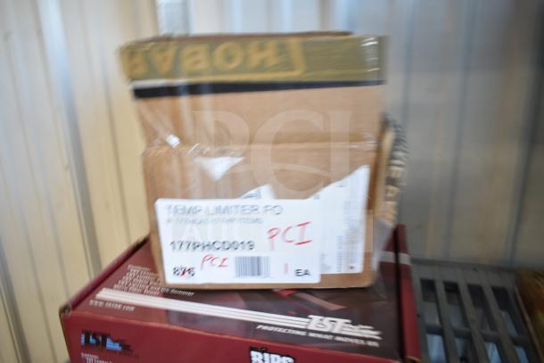 "Lot of 12 items including USA Wolf Streak knife, cordless screwdriver, hitch, and electrical tape, box labeled 'Temp Limiter FO'."