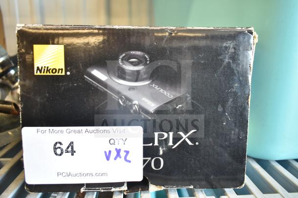 Nikon CoolPix digital camera box showing model S570 and logo, with visible auction tag number 64 and site URL.
