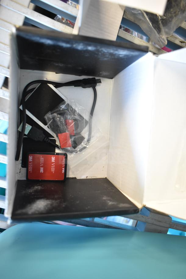 Box containing A119 Dash Camera accessories, including cables and mounting pads. Excellent condition, ready for installation.