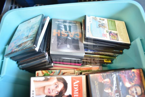 Lot of various DVDs in a blue poly bin, includes titles like "Crash," assorted genres and conditions.
