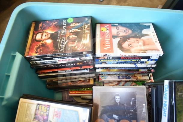 Lot of various DVDs in poly bin, featuring titles like "Angels & Demons" and "Admission." Mixed titles and conditions.