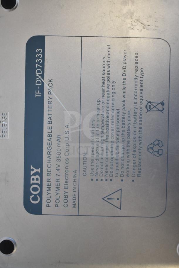 Coby TF-DVD7333 polymer rechargeable battery pack label with caution instructions and specifications visible.
