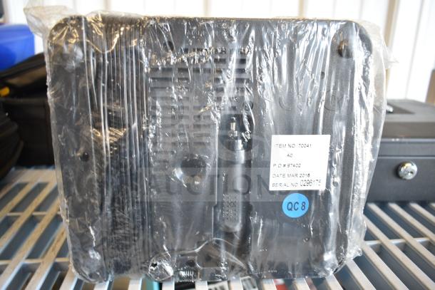 Plastic-wrapped items including SentrySafe cash box and flat tire repair kit. Visible label shows item and serial numbers.
