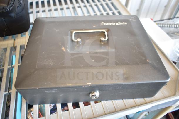 SentrySafe cash box with handle and lock, minor wear. Includes a flat tire temporary repair kit.