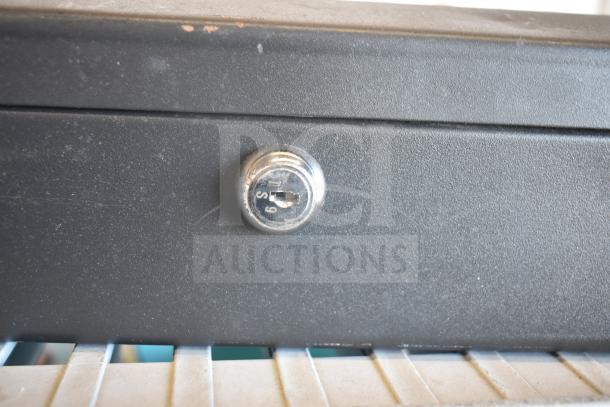 SentrySafe cash box with lock, shown in used condition. Includes flat tire repair kit. Auction lot: double bid value.