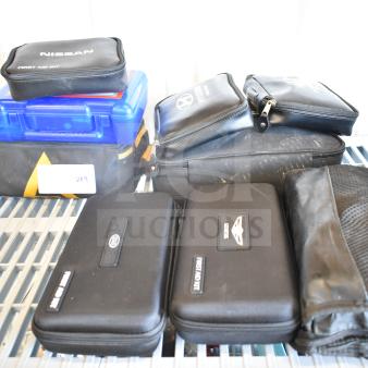 Assorted first aid and roadside kits from Hyundai, Nissan, Genesis, Kia, and Volkswagen on a shelf; varying conditions.