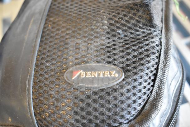 Sentry bag with mesh exterior, featuring a Sentry logo emblem. Condition appears used. Contains various branded kits.