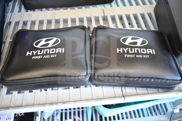 Hyundai first aid kits in black zippered cases, part of a 9-piece auction lot.