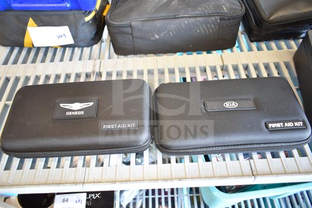 9 car kits including Genesis and Kia first aid kits on shelf. Includes Volkswagen VW roadside assistance kit. Various brands.