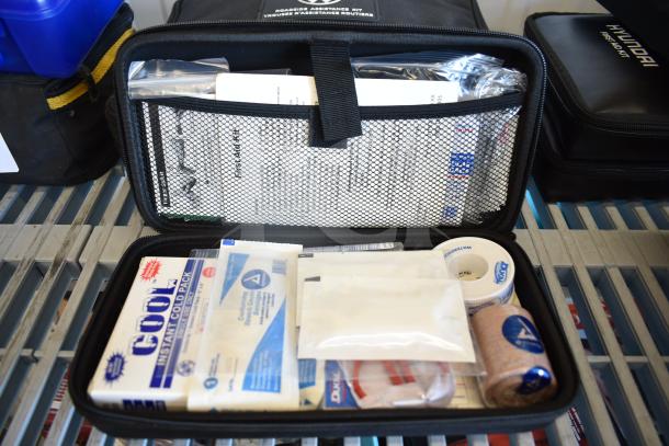 Various first aid kits from Hyundai, Nissan, Genesis, Kia, and VW roadside assistance kit, new condition.