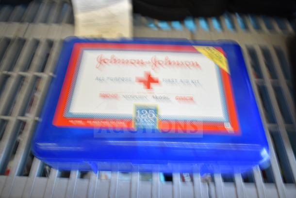 Blue Johnson & Johnson all-purpose first aid kit with a white label, featuring Band-Aid, Neosporin, Motrin, and Coach logos.