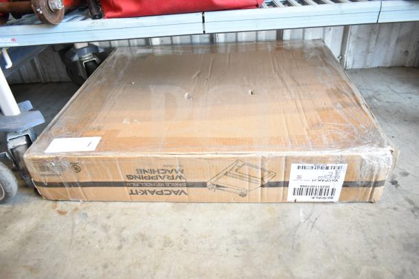 Brand new VacPak-It 186WM18 wrapping machine in box. Minor box damage. 115V, single phase. Barcode visible.