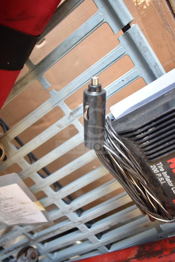 Max Power Tire Inflator with 200 PSI capacity and power cord. Includes red floor jack. Components appear in used condition.
