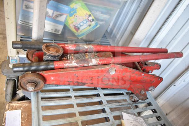 Red floor jack with visible rust and wear, paired with Max Power tire inflator compressor, in used condition.