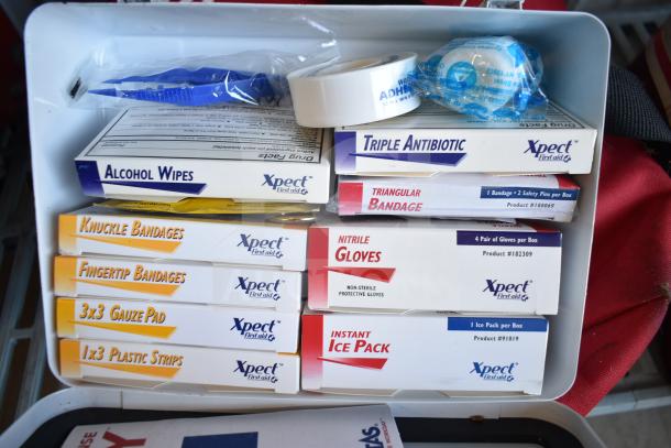 Cintas first aid kit with bandages, gloves, antibiotic ointment, and ice pack. Includes various Xpect branded supplies.
