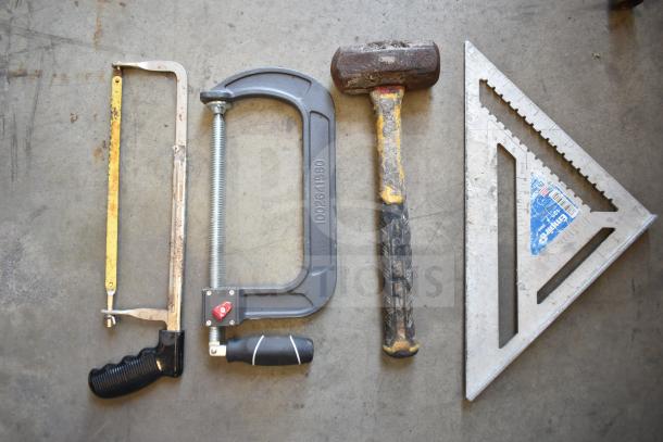 Various tools including a hacksaw, C-clamp, mallet, and square ruler on concrete; signs of wear visible.