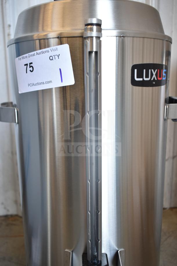 BRAND NEW SCRATCH AND DENT! Fetco TPD-30, 3-gallon stainless steel coffee dispenser, minor scratches, visible label with auction details.