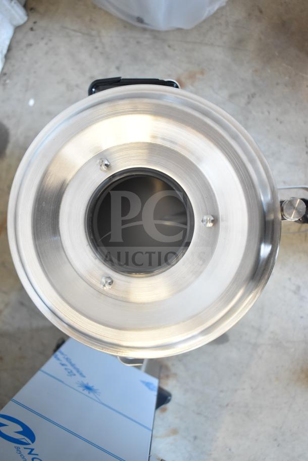 Alt text: Fetco TPD-30 Luxus 3-gallon stainless steel coffee dispenser, brand new with minor scratches and dents, top view.