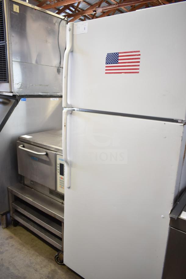 General Electric GE reach-in cooler with freezer, 115 volts, 1 phase, white exterior, American flag sticker.