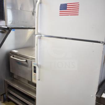 General Electric GE reach-in cooler with freezer, 115 volts, 1 phase, white exterior, American flag sticker.