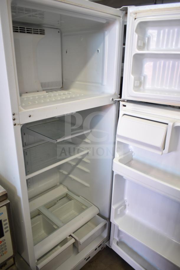 General Electric GE reach-in cooler with freezer, 115 volts, 1 phase, featuring adjustable shelves. Good condition.